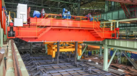 Slab handling overhead crane with tongs supporting efficient operations at steel mills